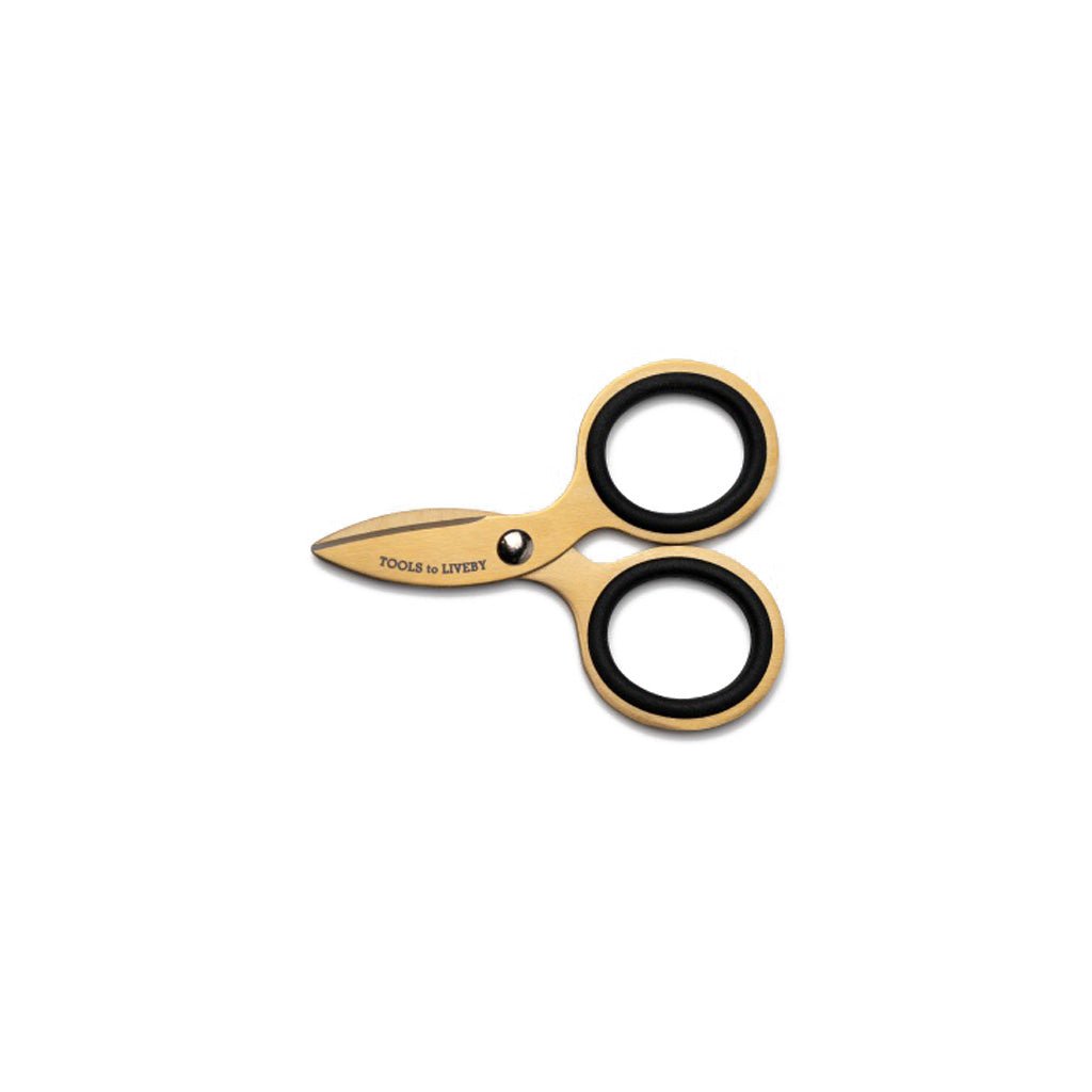 Small gold steel scissors on white background