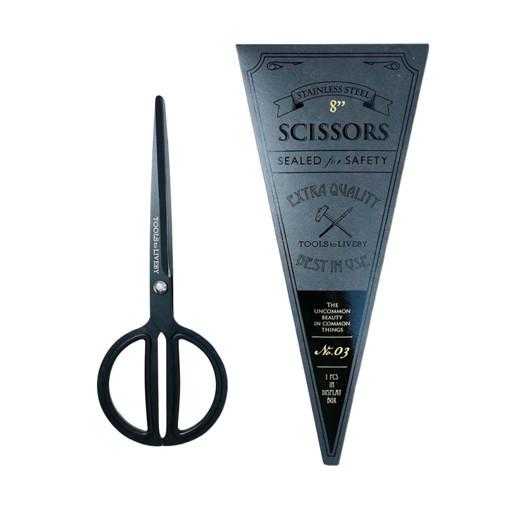 Black metal scissors shown next to their branded black triangular packaging label on a plain white background.