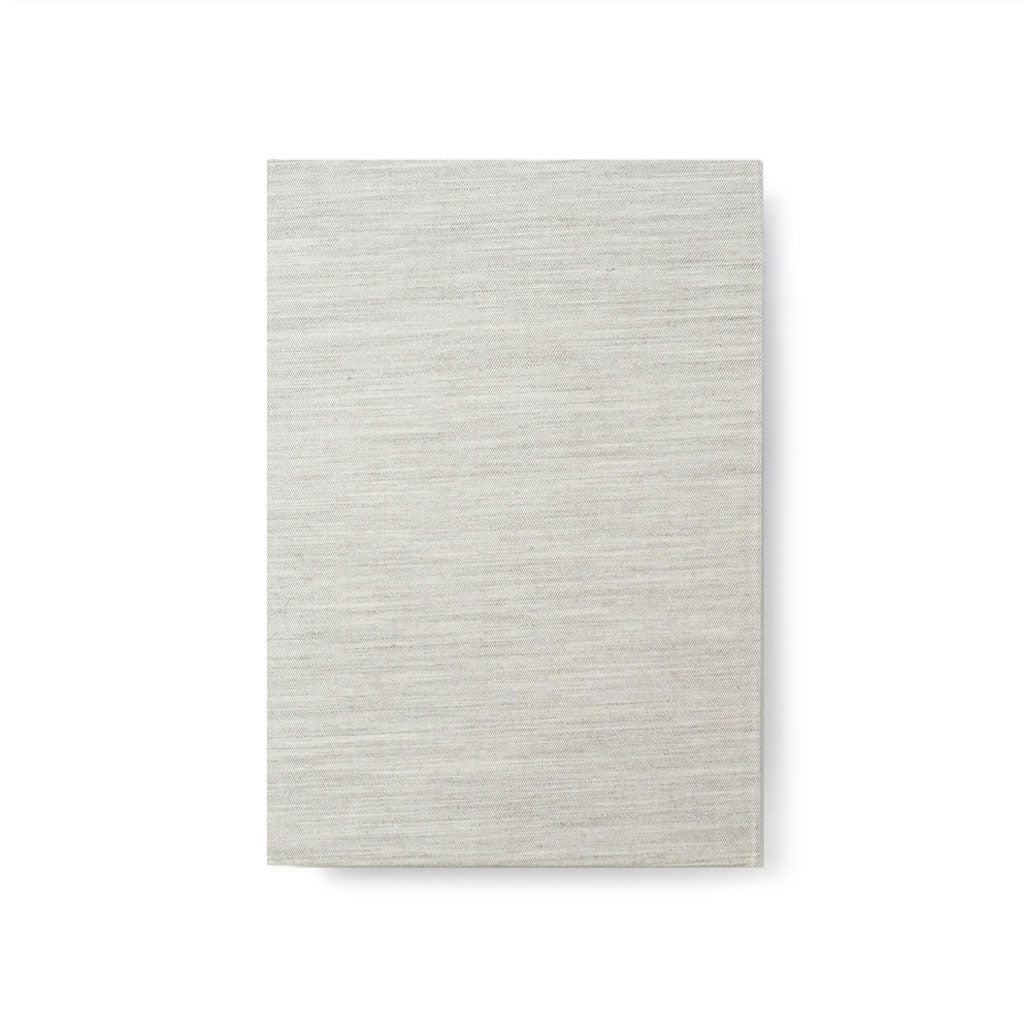 Light grey woven notebook on white background