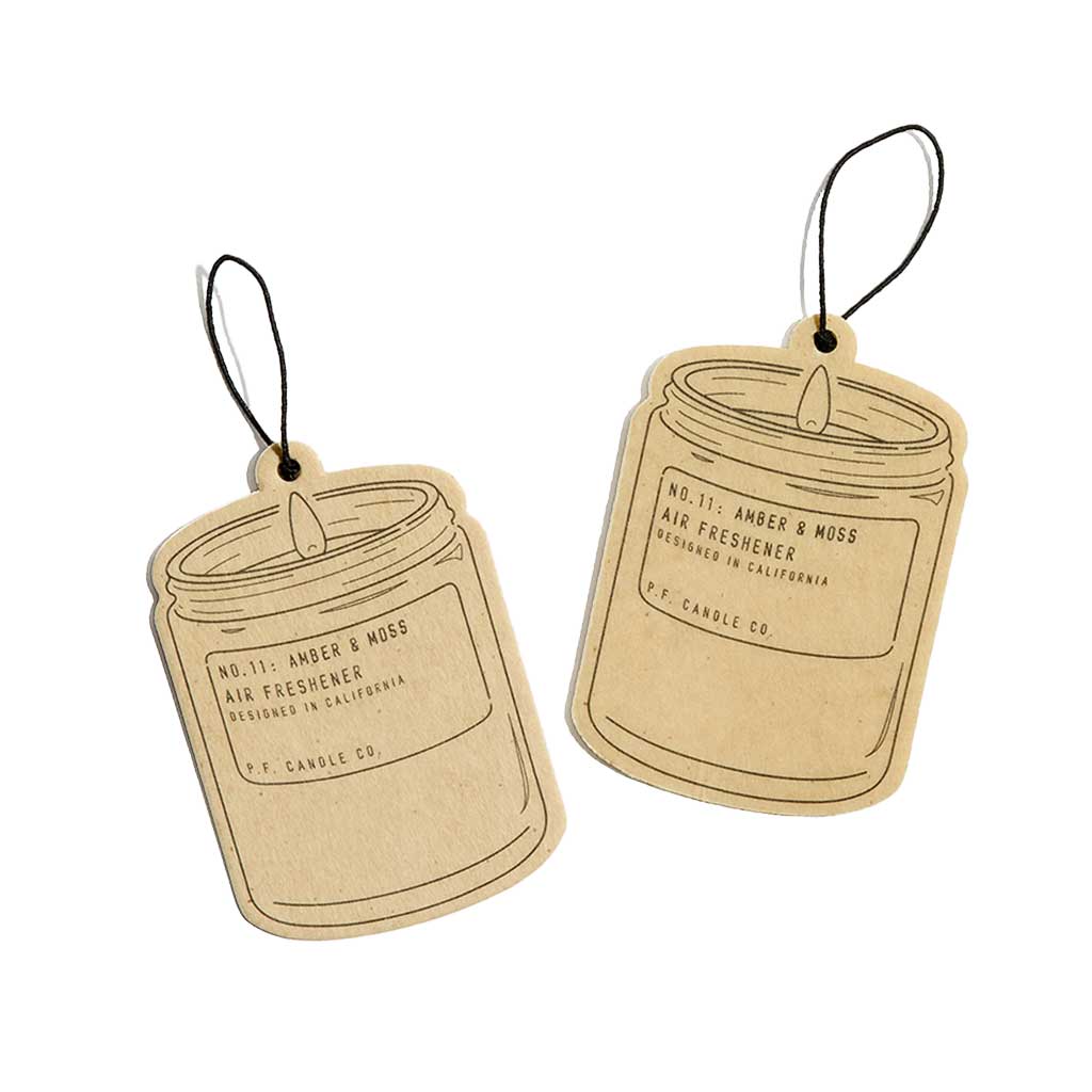 Two cardboard air freshener tags with a candle design on a white background