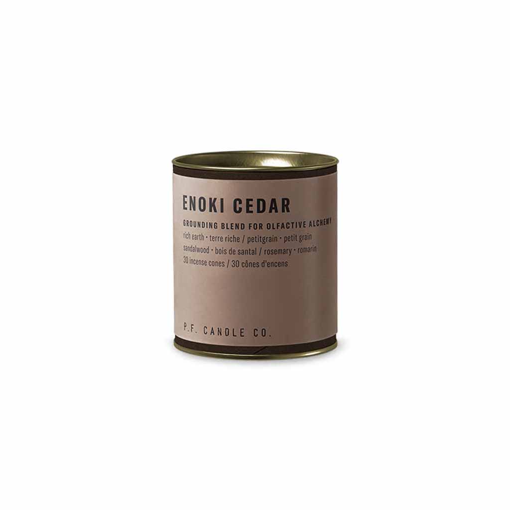 Beige canister of enoki cedar incense cones on white background