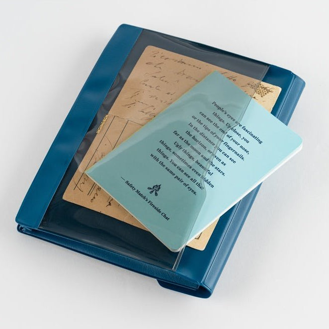 Blue notebook inside pocket of navy blue document case on a white background