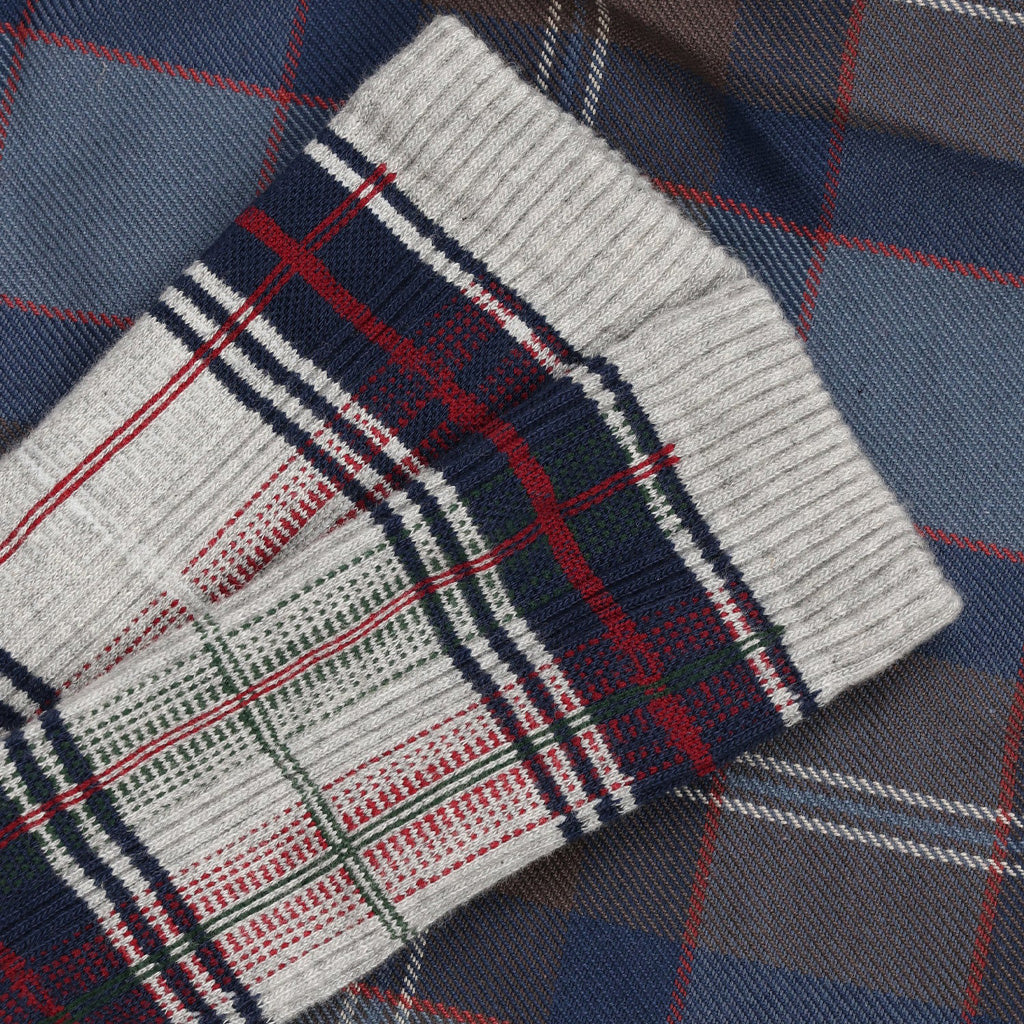 Plaid sock on top of plaid bedding.