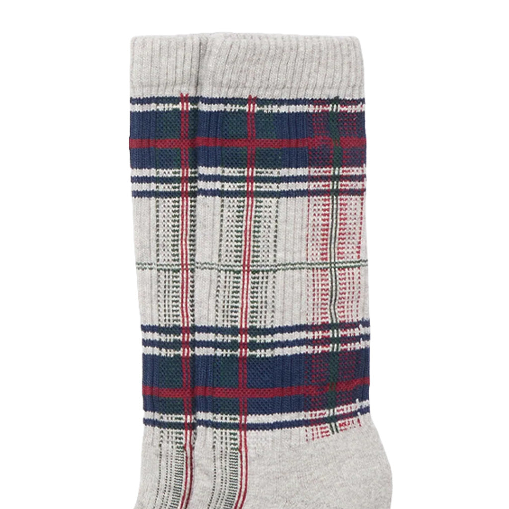 Close-up of a single crew sock with a gray ribbed cuff and toe, featuring a plaid pattern with navy blue, red, and white stripes on a light gray base.