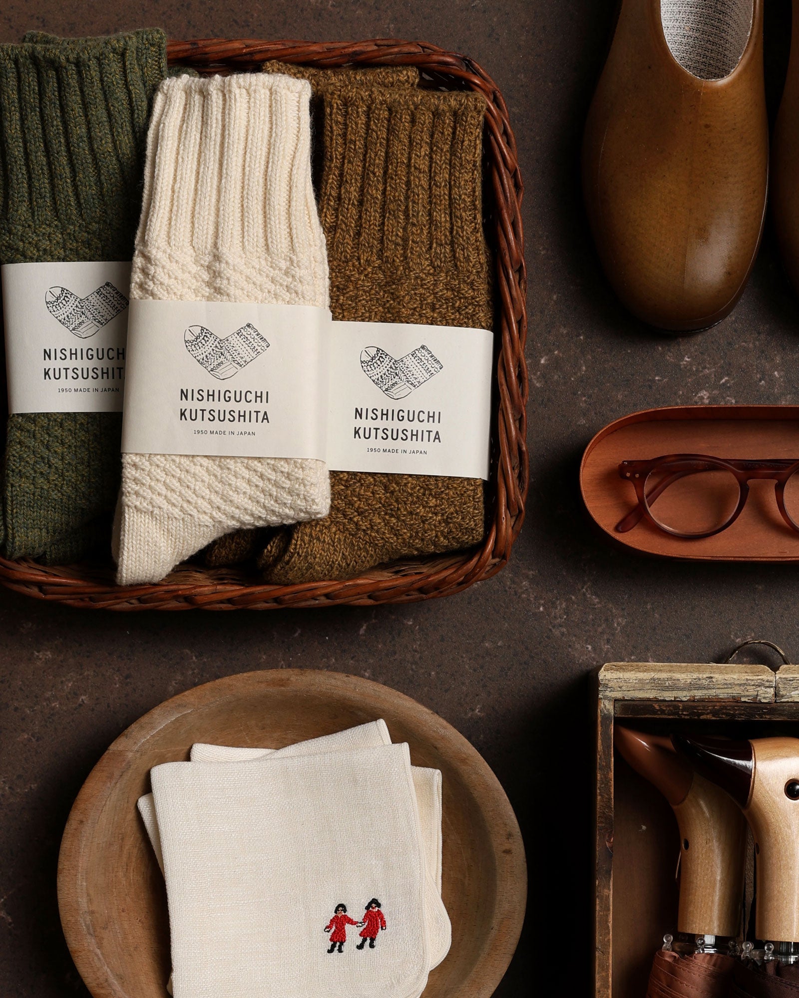 Apparel and accessories arranged on a dark surface.