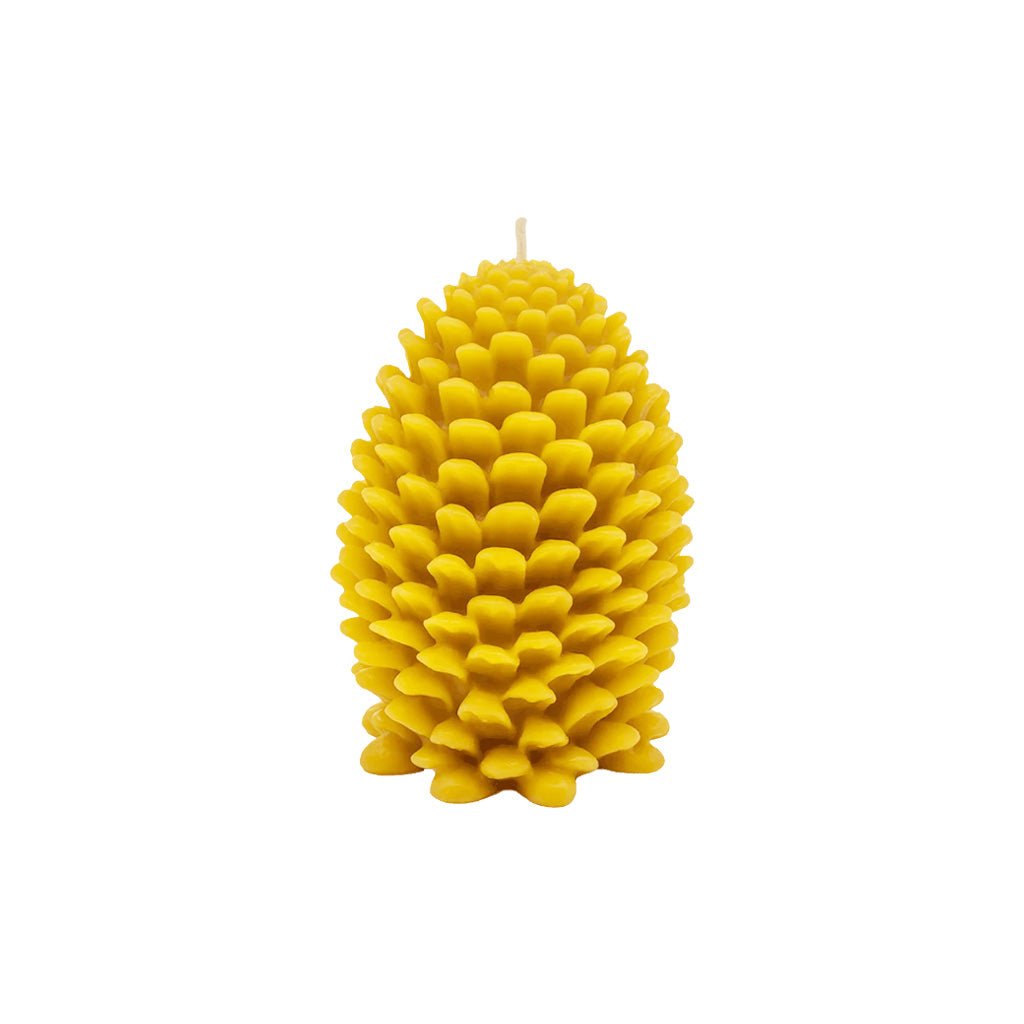 A large bright yellow candle shaped like a pine cone, featuring textured, layered scales and a single wick at the top, isolated on a solid white background.