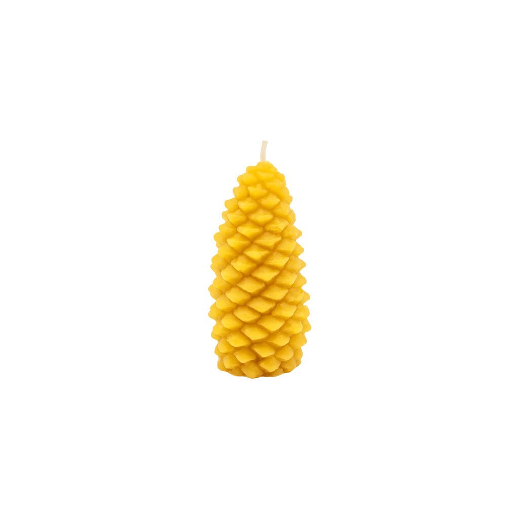 A yellow pinecone-shaped candle with a textured, layered scale design and a small white wick at the top, centered on a plain white background.