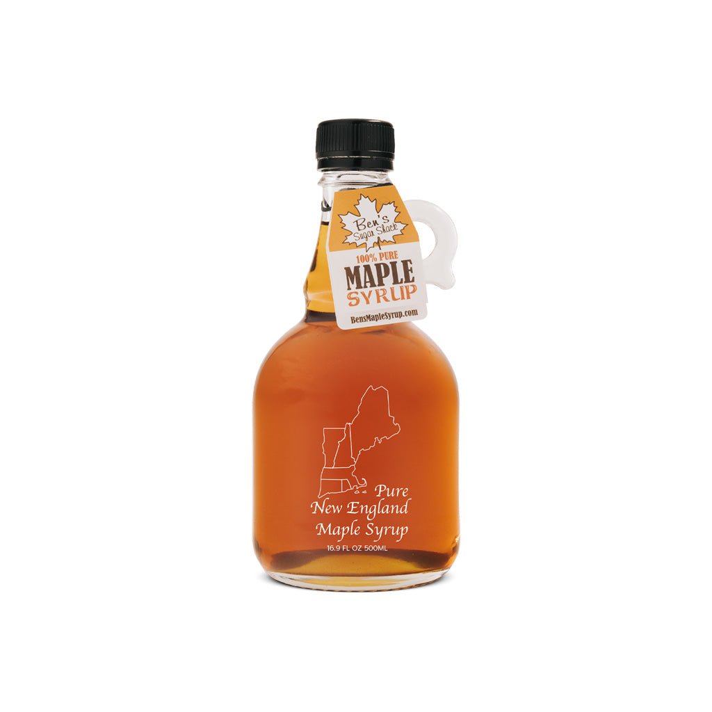 Glass jug of New England Maple Syrup with handle and black cap.