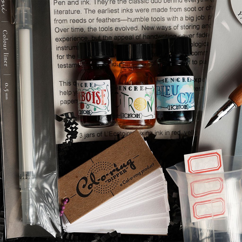 Ink bottles and stationery items like color testing papers and tiny labels.