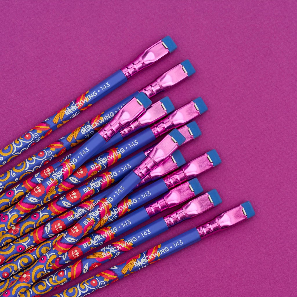 Pile of Blackwing 143 pencils on purple background.