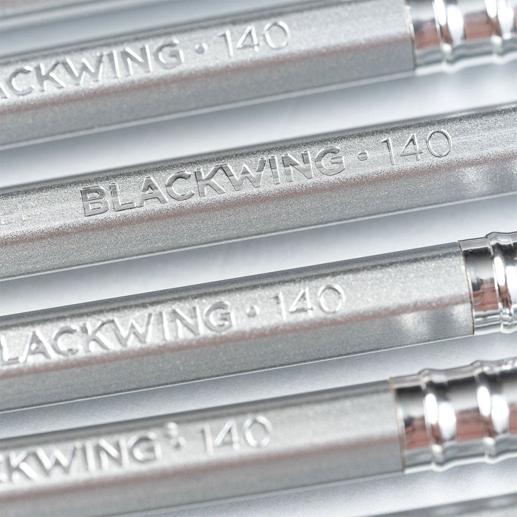 A close-up photo showing the Blackwing logo and the number 140 imprinted on several pencils.