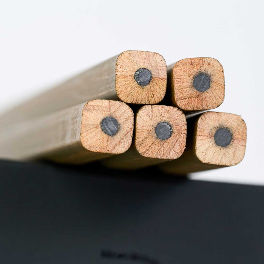 A close-up photo showing the ends of five unsharpened Blackwing Volumes 21 pencils The pencils have a unique, square shape.