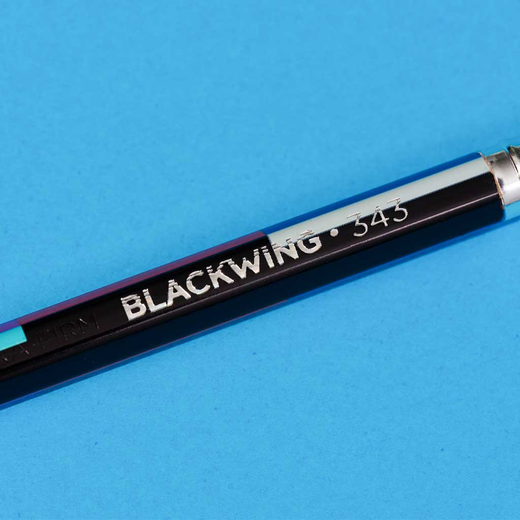 Blackwing 343 pencil on a blue background