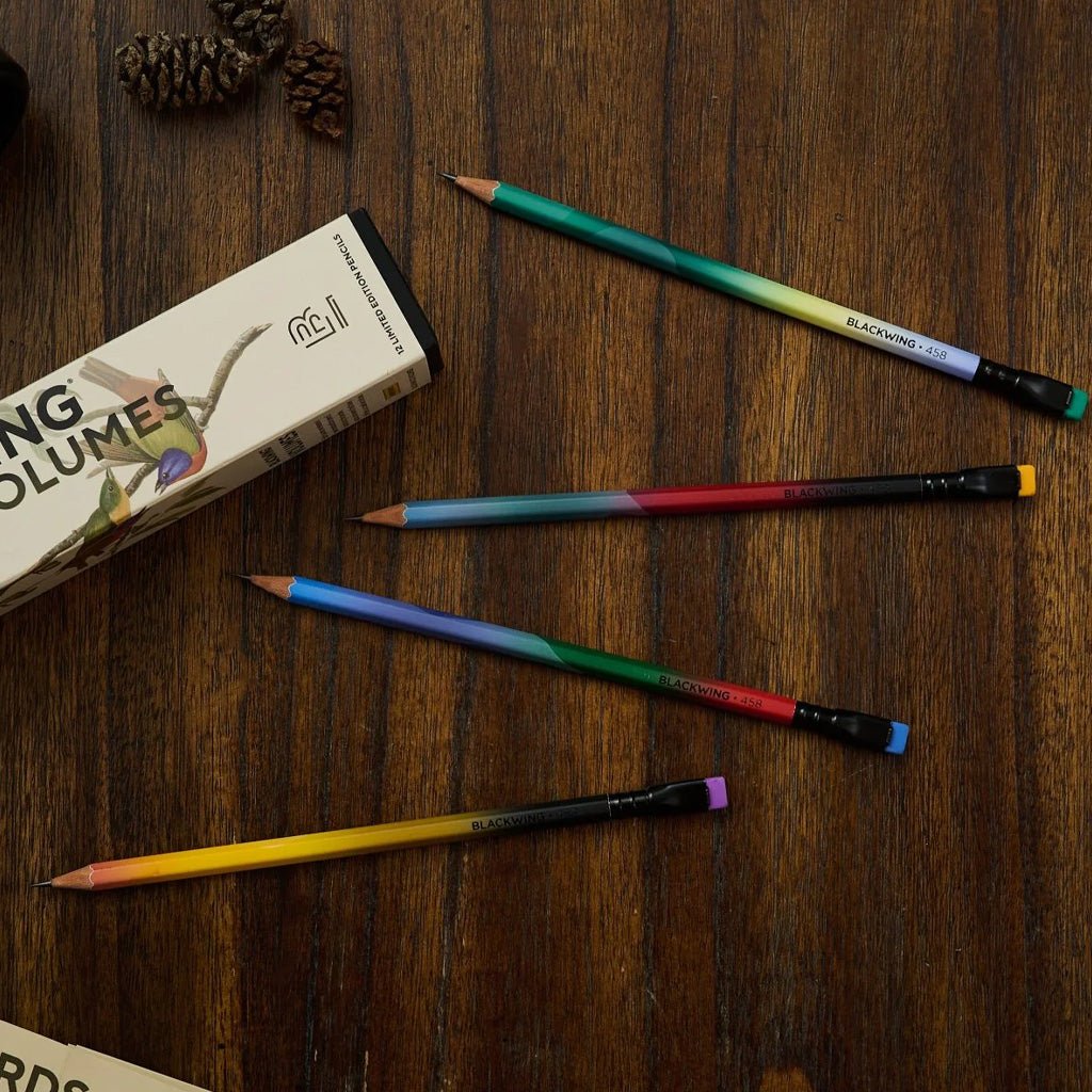 Blackwing 458 pencils with gradient designs next to packaging on wooden background