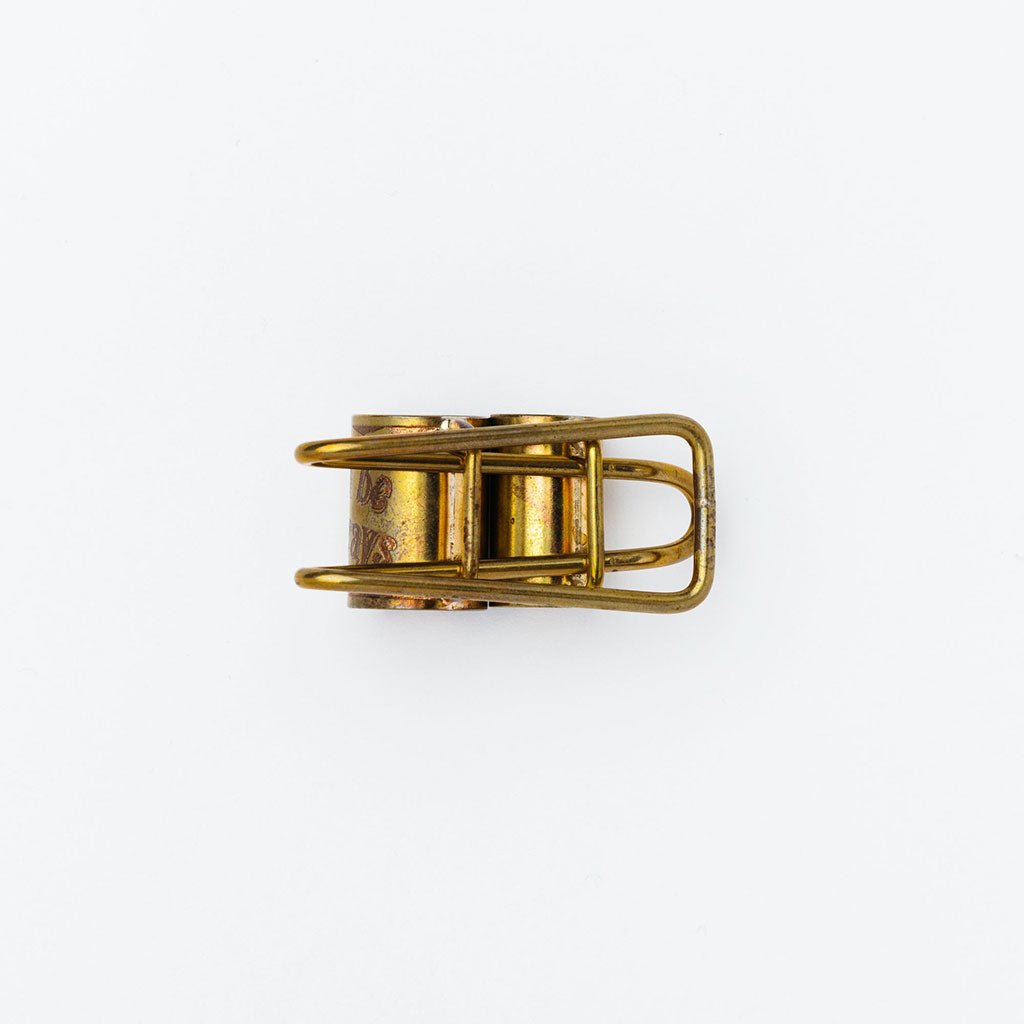 Brass pen clip on white background
