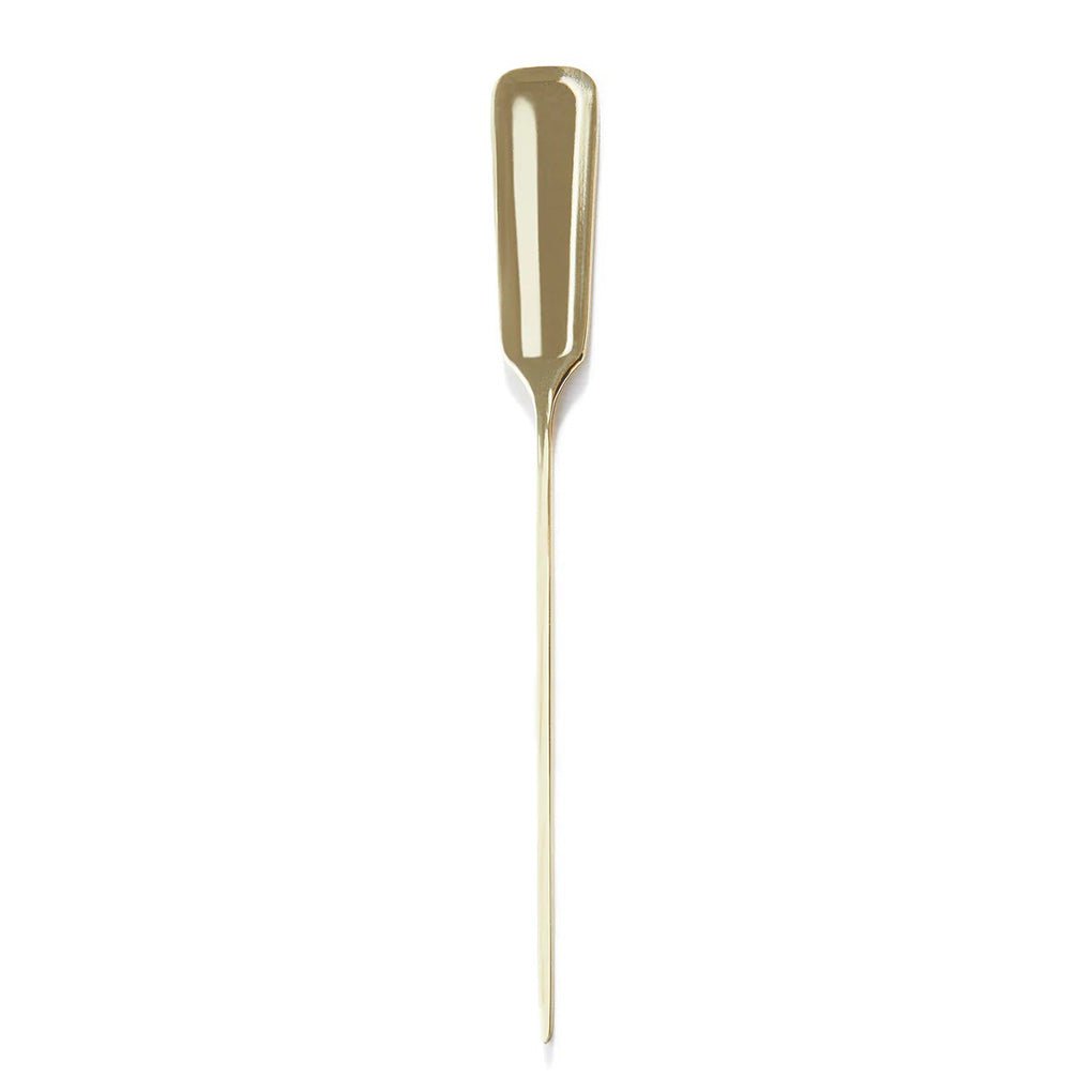 Close up of gold-plated stainless steel cocktail pick on white background