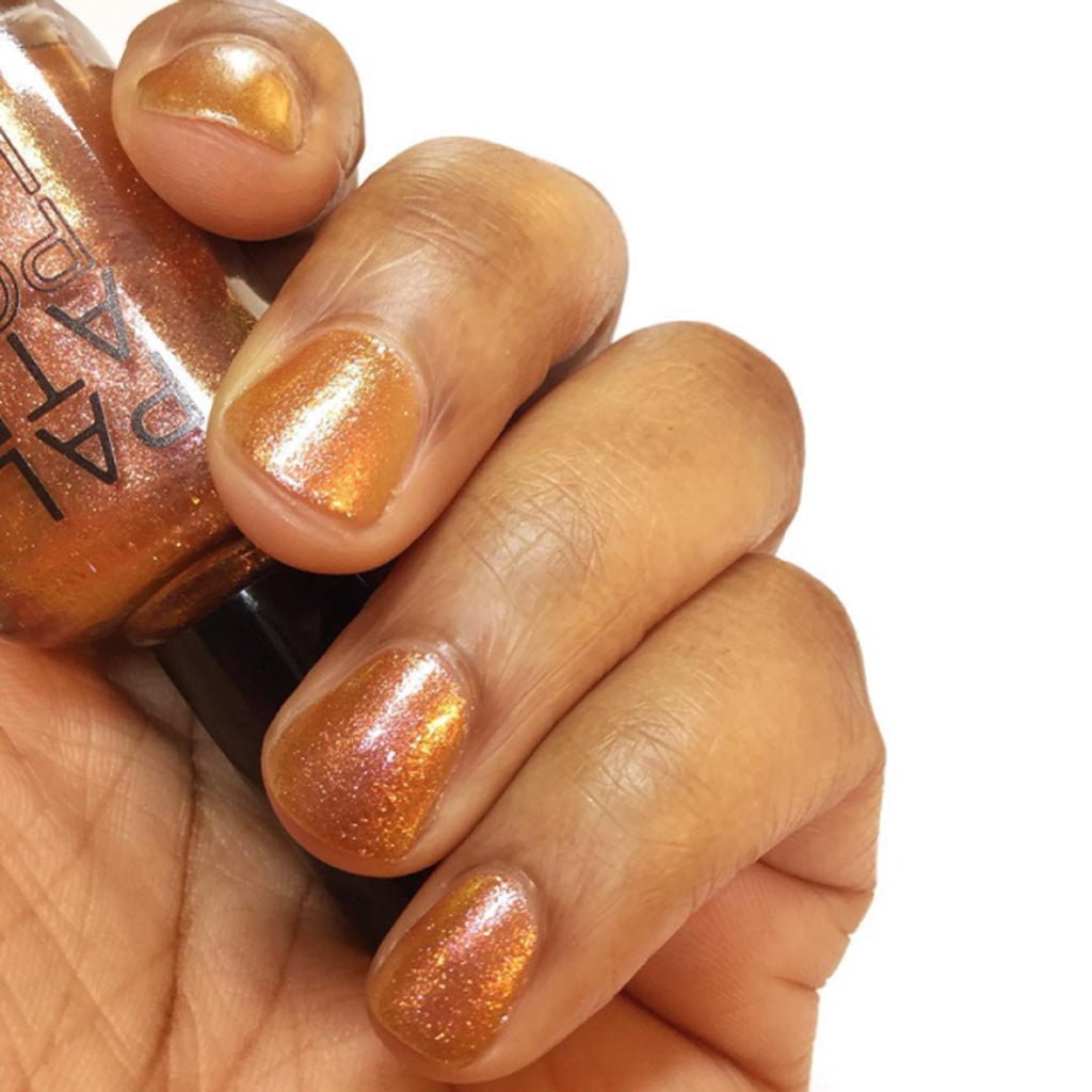 Hand wearing shimmer brown sugar nail polish