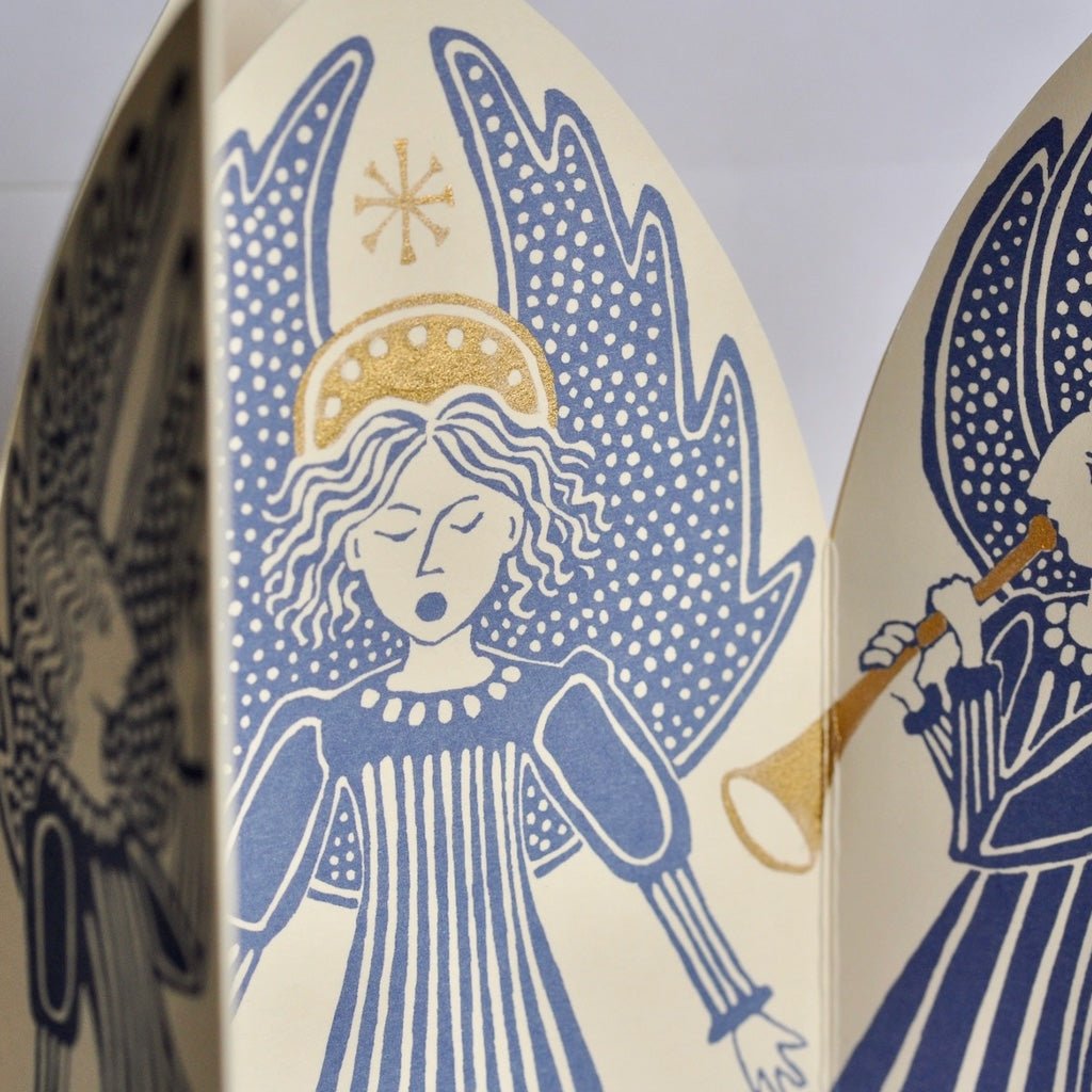 Close-up of blue angel illustration with gold foil details.