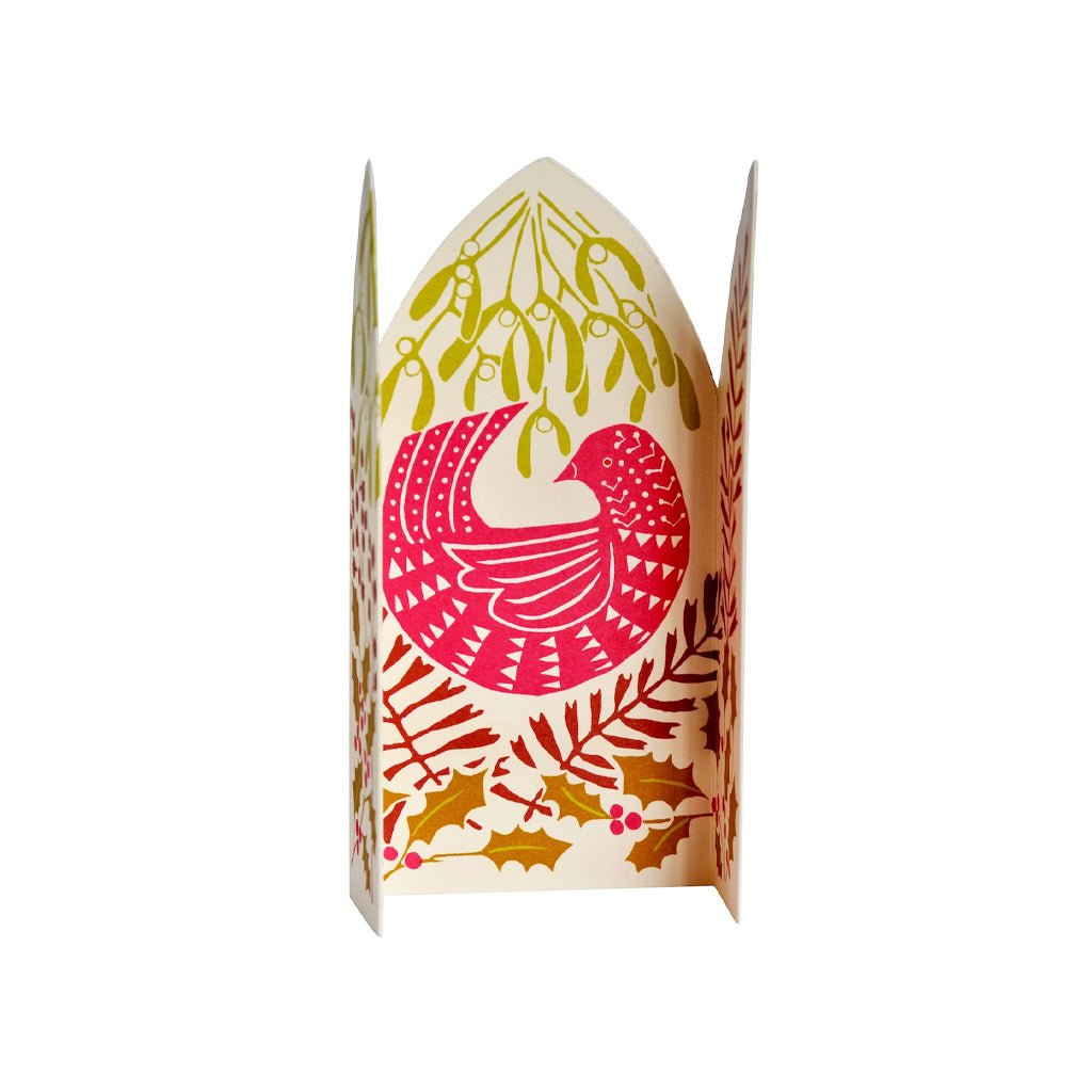 An unfolded festive paper greeting card featuring a stylized bird in pink and red, surrounded by mistletoe, holly leaves, and berries on a white background.