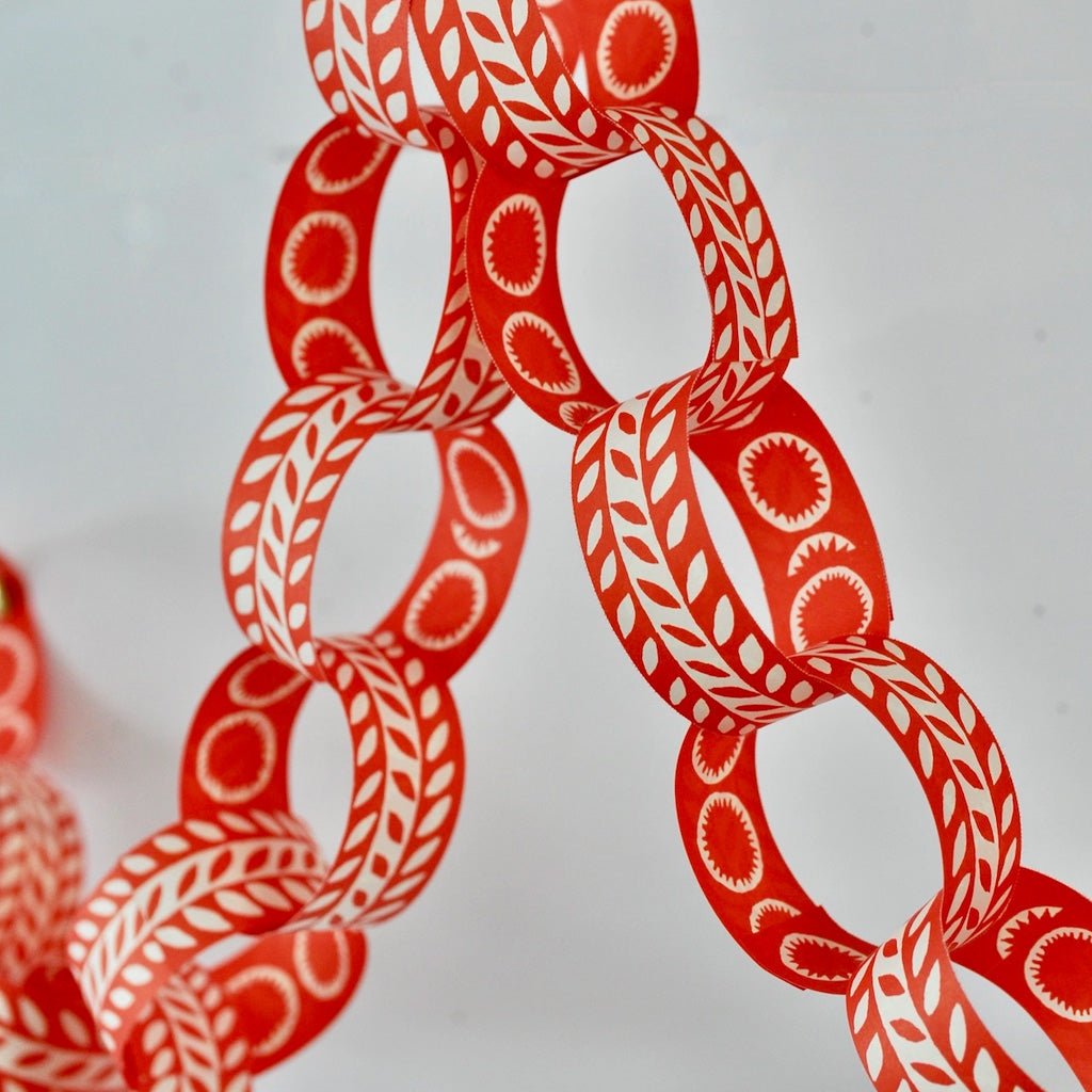 Red and white paperchain rings assembled in a garland.