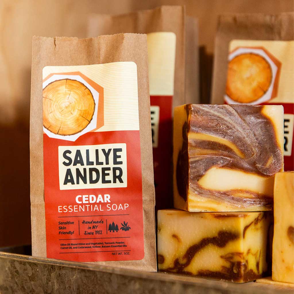 Blocks of swirled SallyeAnder cedar essential soap on shelf