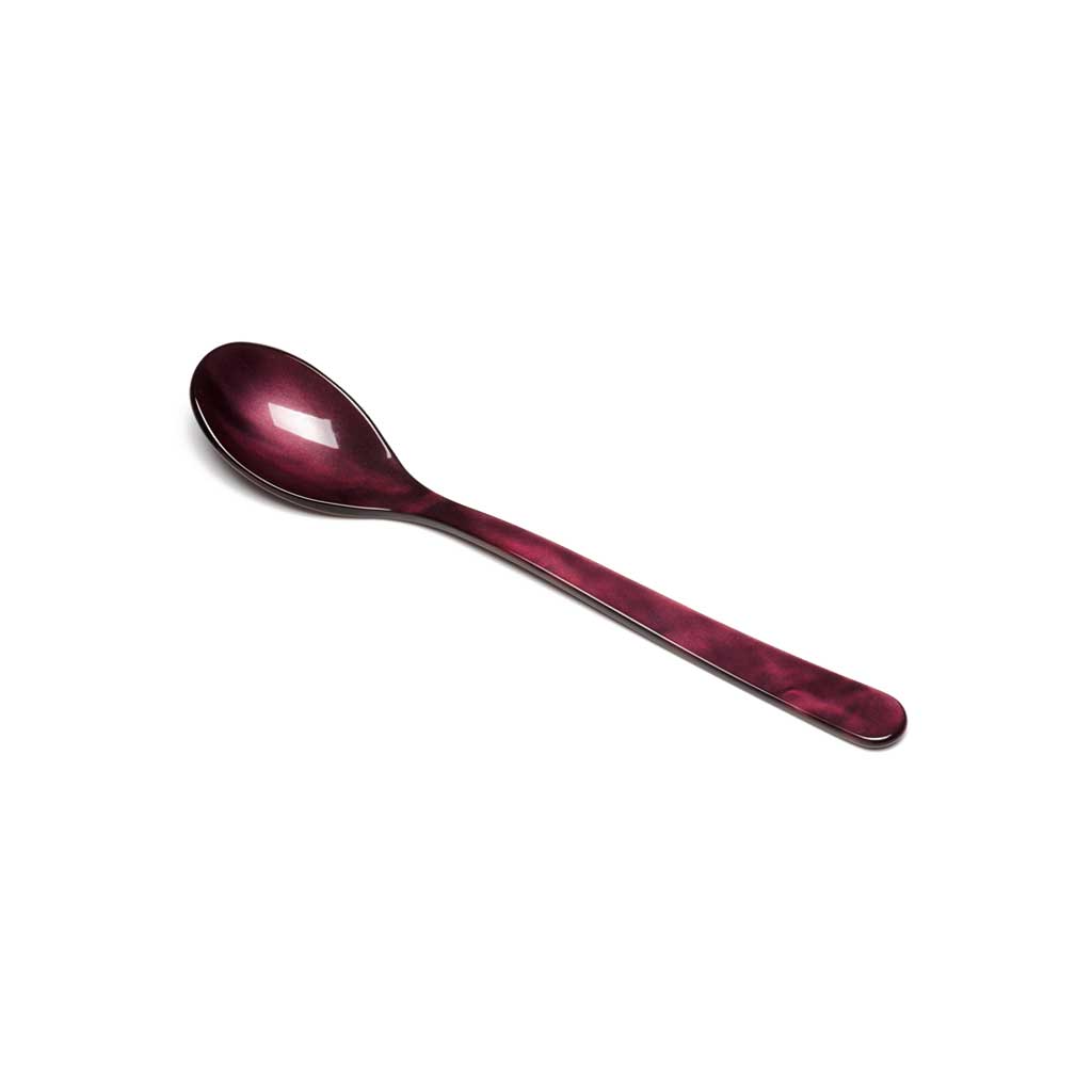 Purple wine colored acrylic cereal spoon on white background