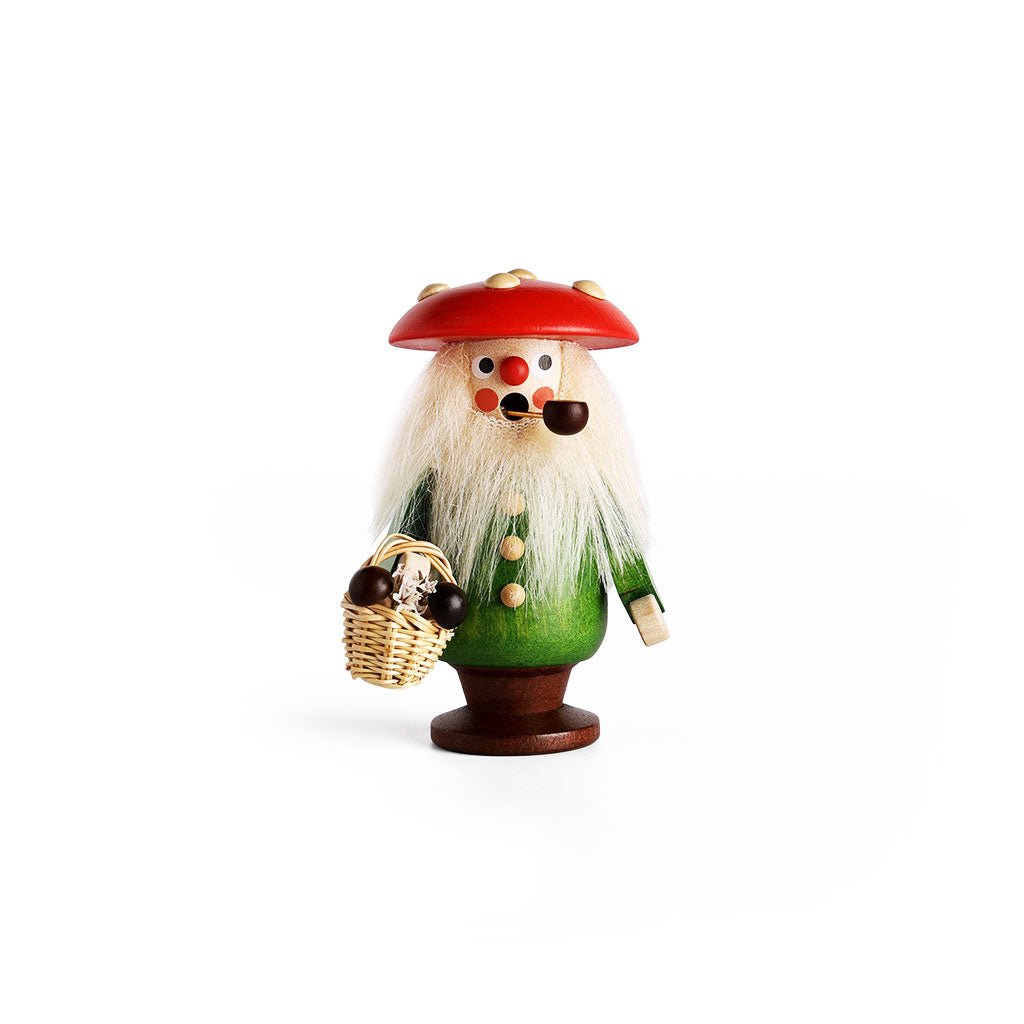 A handcrafted wooden incense burner figurine of a mushroom man with a red cap, green coat, white beard, and a basket of mushrooms.
