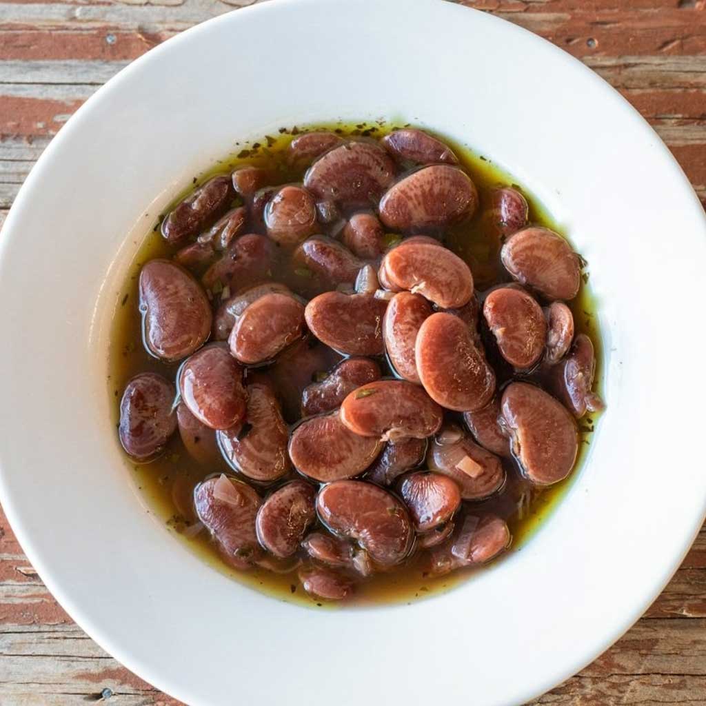 Bowl of christmas lima beans in sauce and herbs
