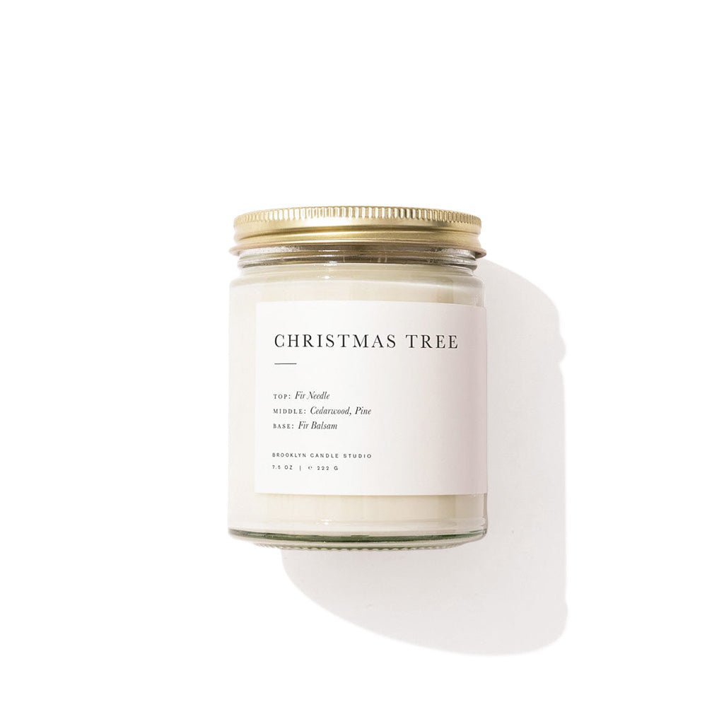Candle with 'Christmas Tree' label on a white background