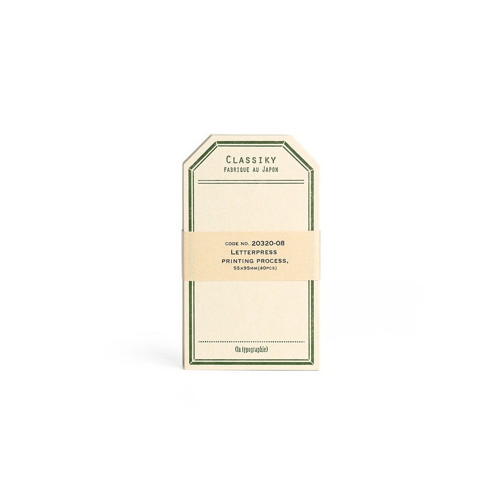 Tag-shaped cream letterpress stationery cards with a green border.