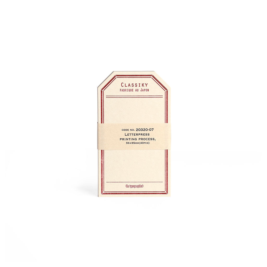 Tag-shaped cream letterpress stationery cards with a red border.