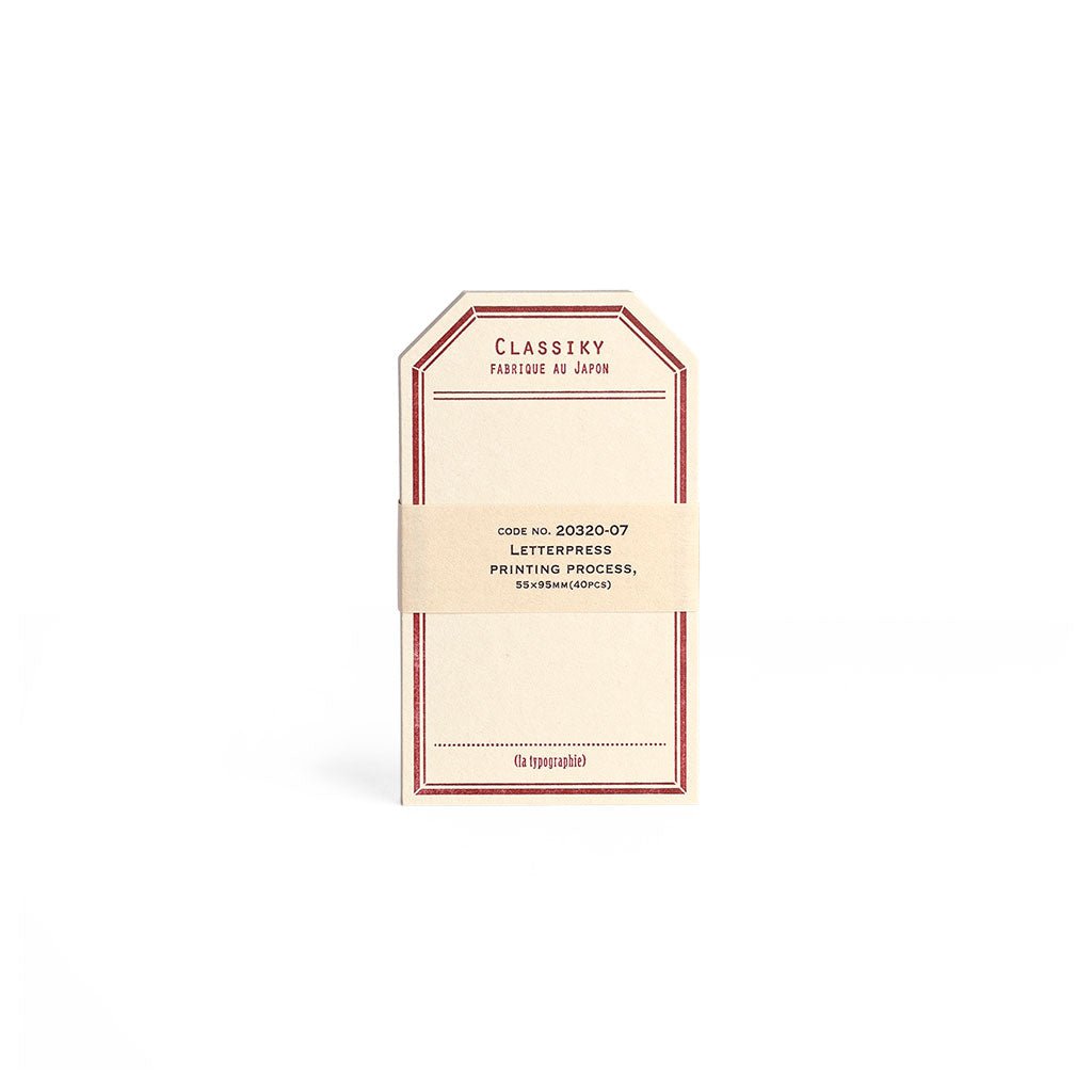 Tag-shaped cream letterpress stationery cards with a red border.