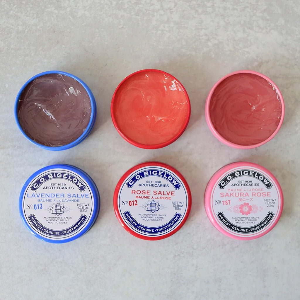 Three tins of salves open.