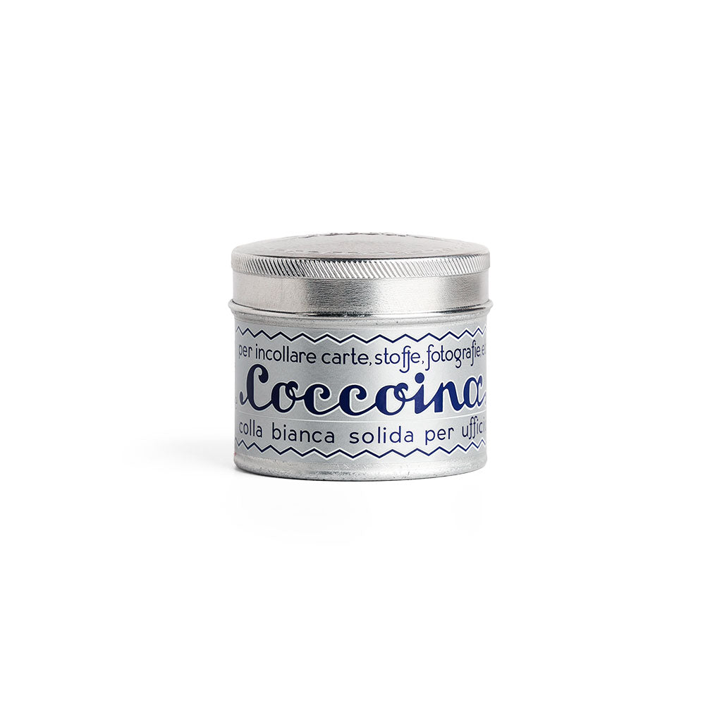 Tin of Coccoina adhesive paste on white background