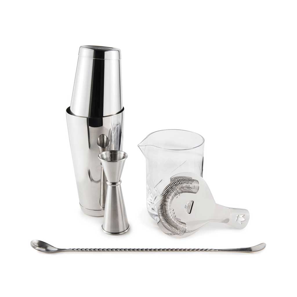Set of cocktail-making tools including a shaker, jigger, measuring cup, and strainer on a white background.