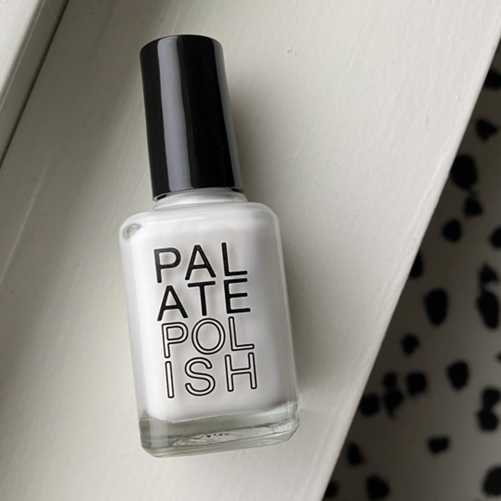 Bottle of white coconut nail polish on white background