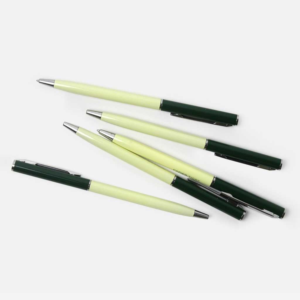 Five pens with green and yellow accents on a white background