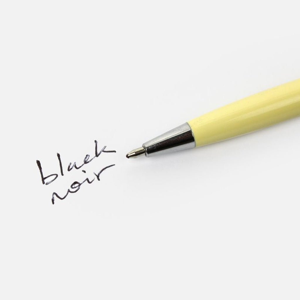 Yellow pen with 'black noir' text on a white background