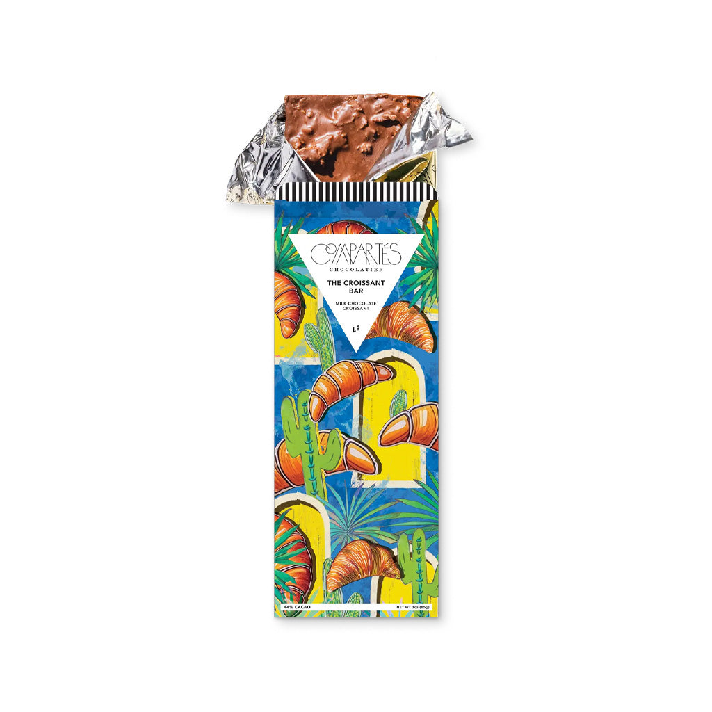 Croissant chocolate bar in gold foil and colorful packaging.