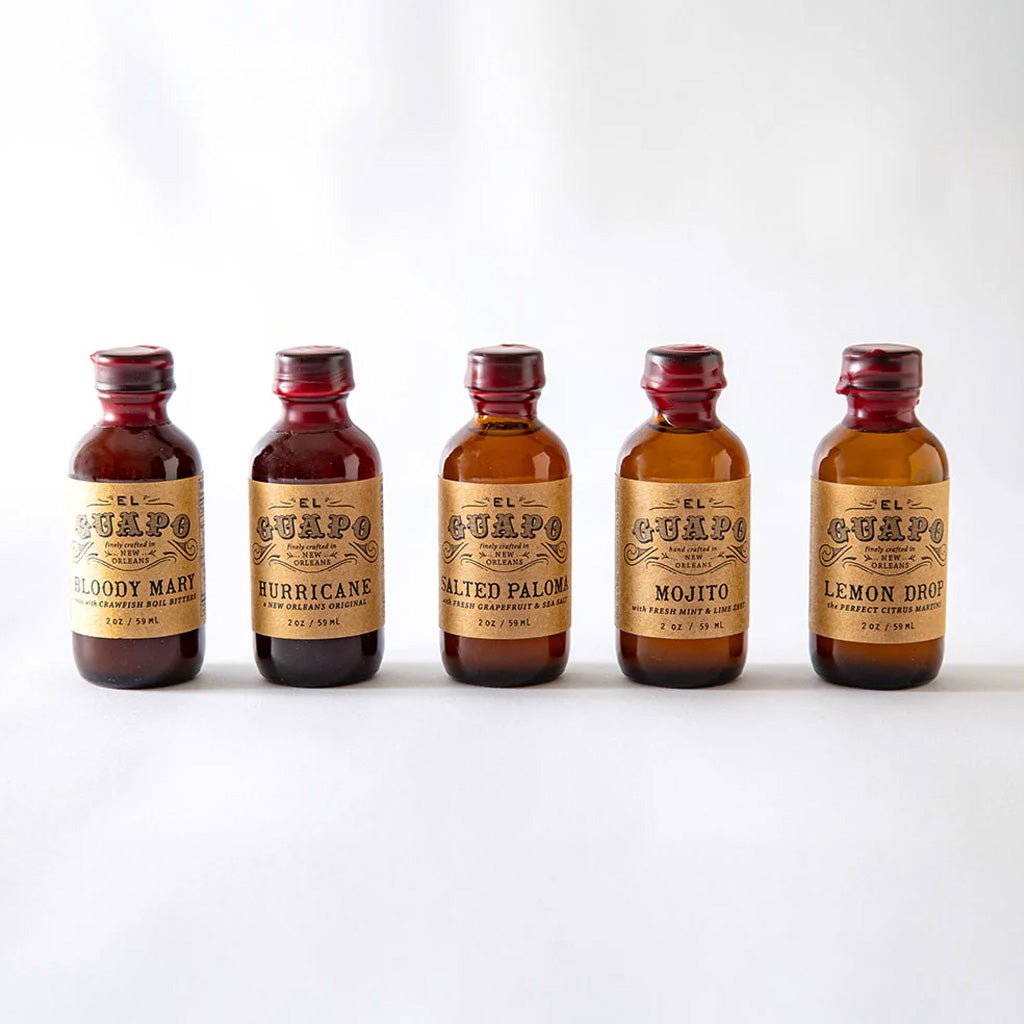 Five small bottles of El Guapo mixers on a white background