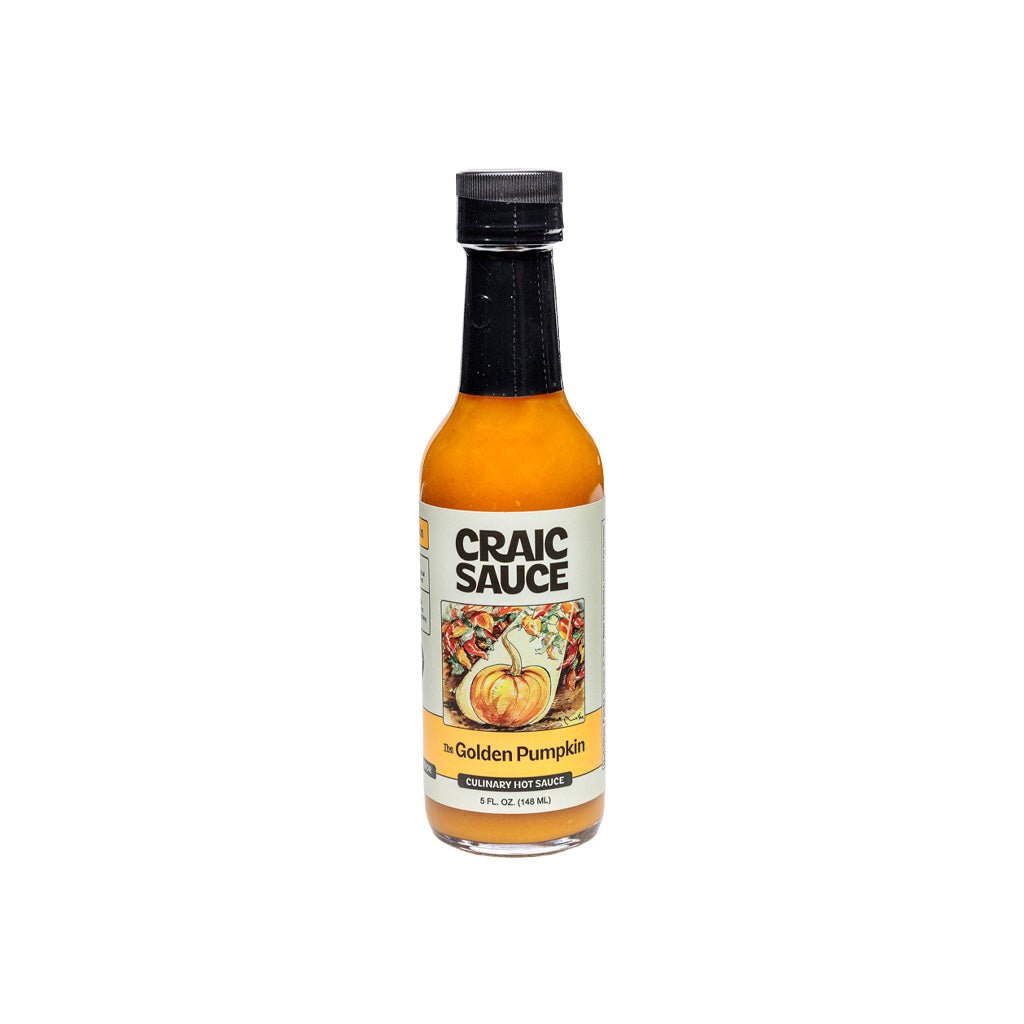 A bottle of Craic Sauce Golden Pumpkin hot sauce on a plain white background.