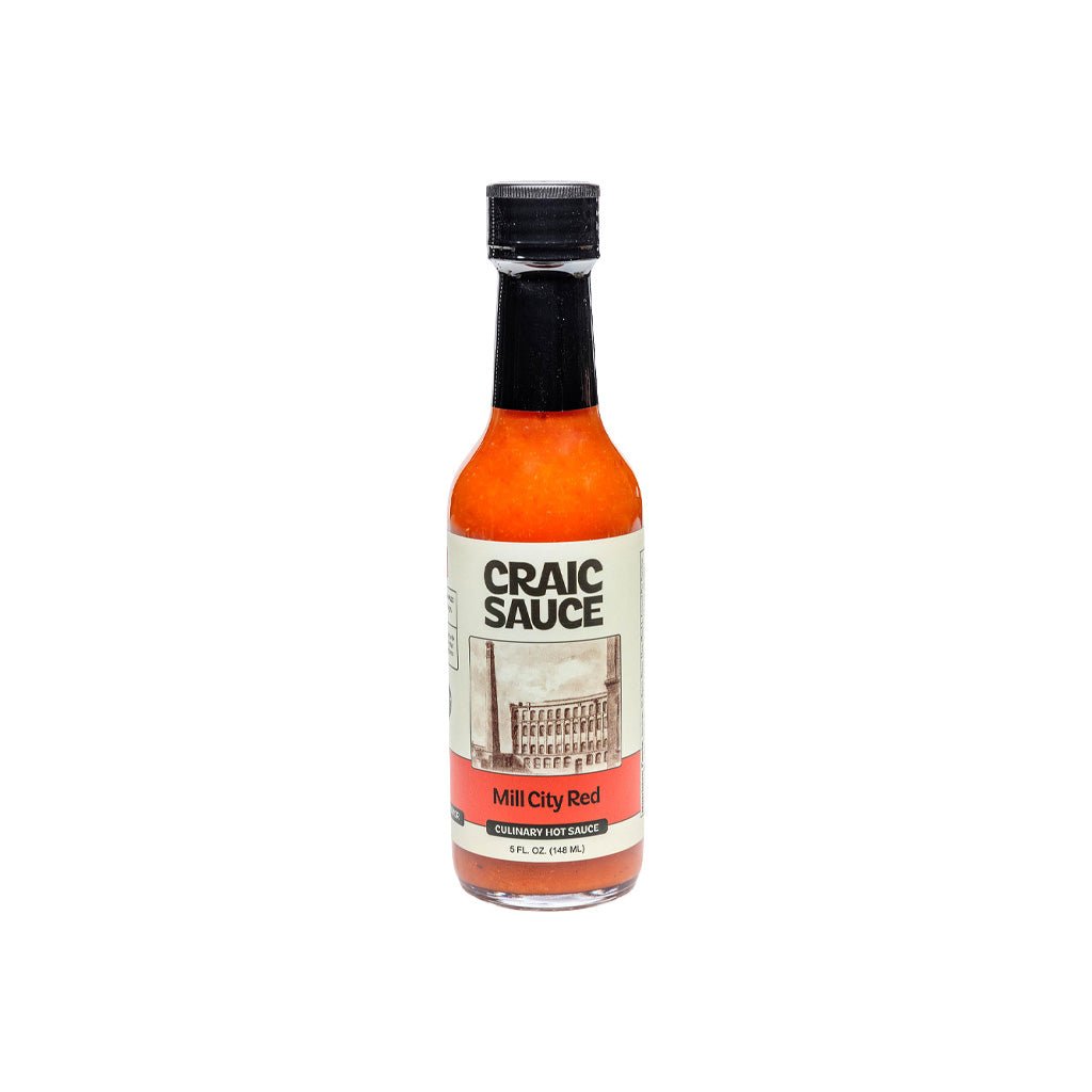 A bottle of Craic Sauce Mill City Red hot sauce on a plain white background.
