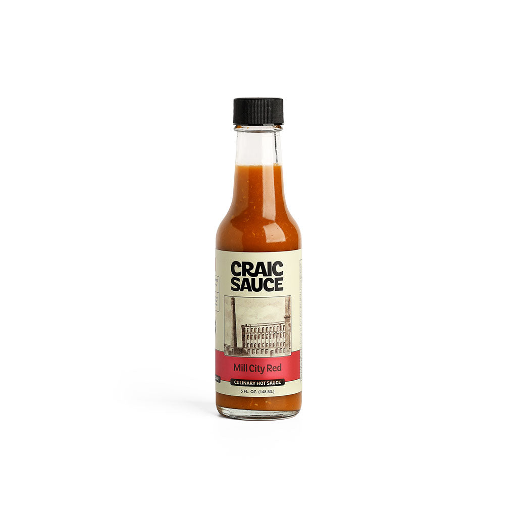 A bottle of Craic Sauce Mill City Red hot sauce.