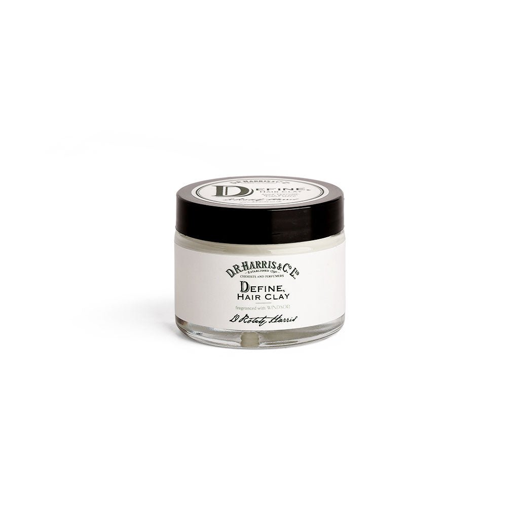 Small tub of D. R. Harris define hair clay with black screw lid on white background