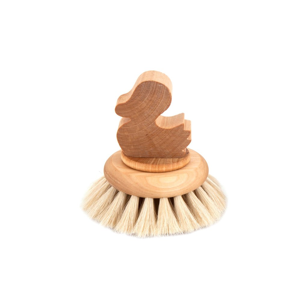 Wooden bath brush with duck motif and horsehair bristles on white background