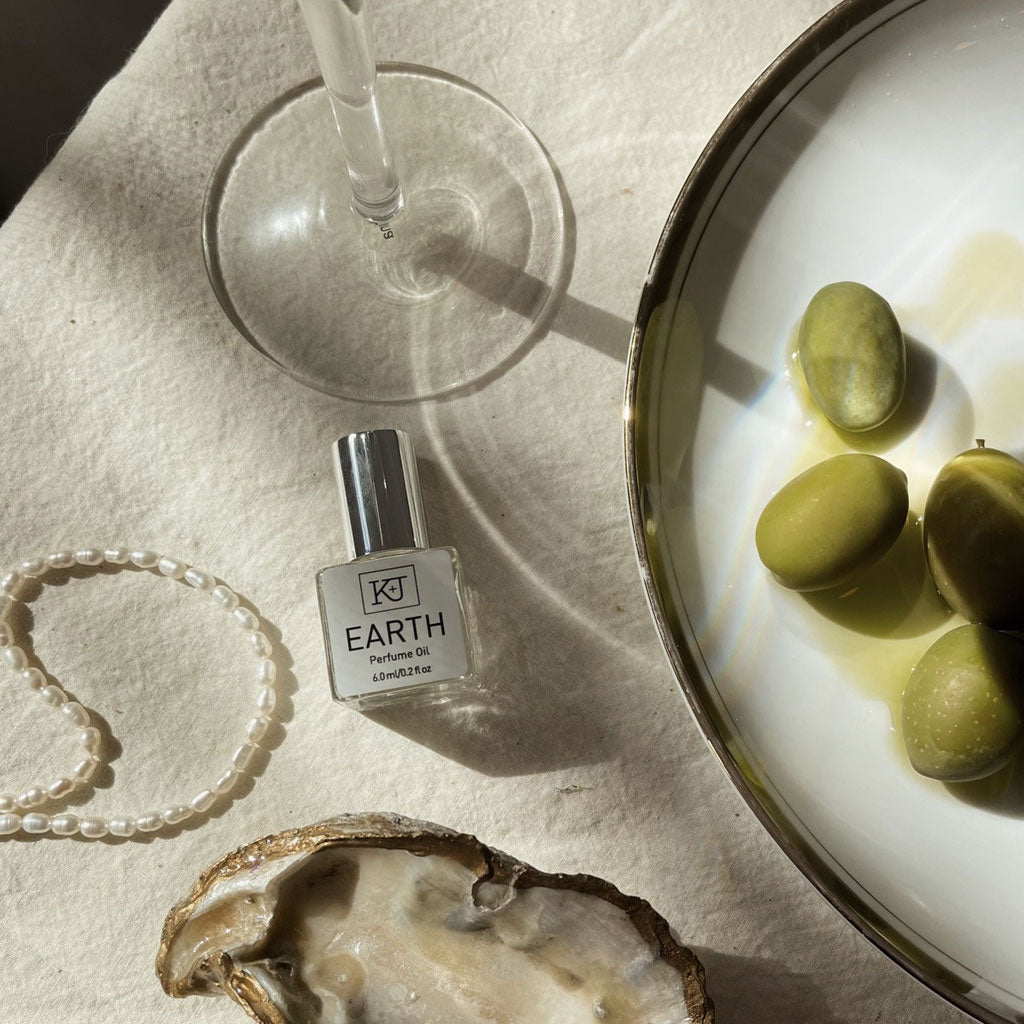 Bottle of earth perfume oil laying on table