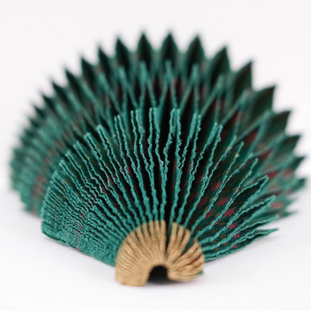 Paper tree decoration with honeycomb layers at an angle.