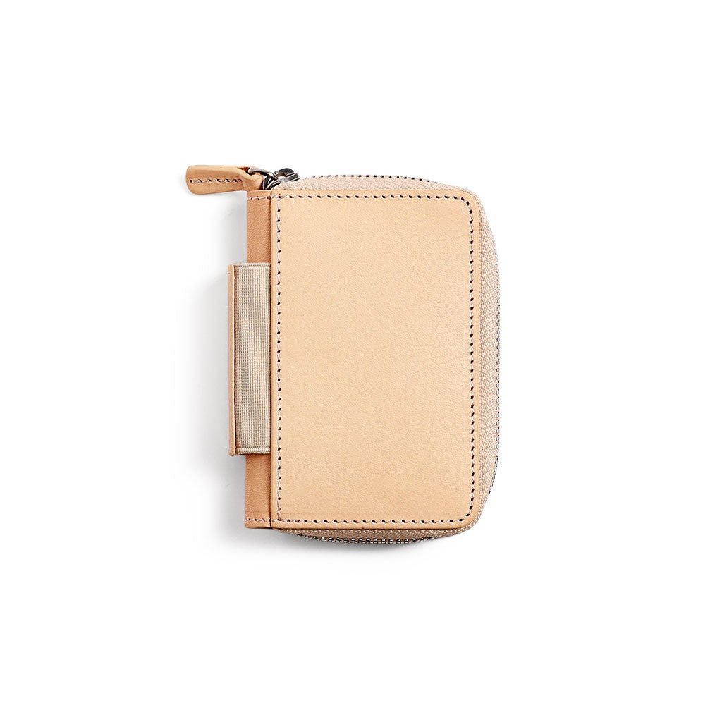 Natural undyed leather zippered wallet on white background