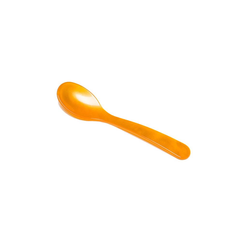 Orange acrylic egg spoon on white background
