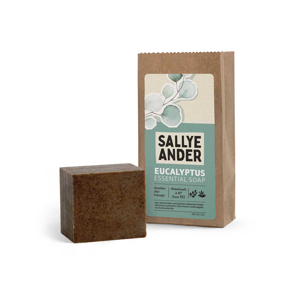 Bar of dark brown SallyeAnder eucalyptus essential soap next to packaging on white background